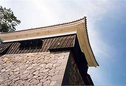 A close up shows the ishiotoshi (openings through which stones could be dropped on adversaries).